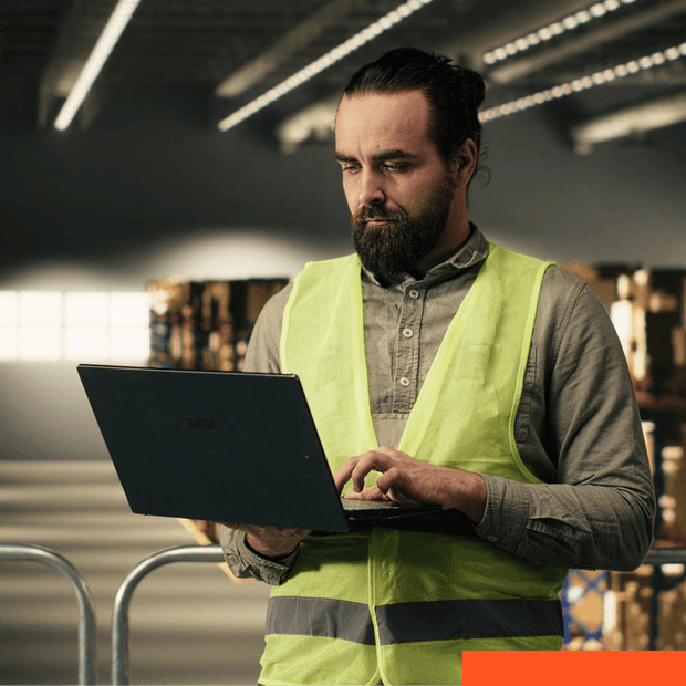 Engineer using a laptop in an industrial facility