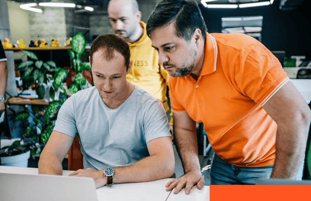 Cloud-Native Application Development Software developers reviewing application architecture on a monitor