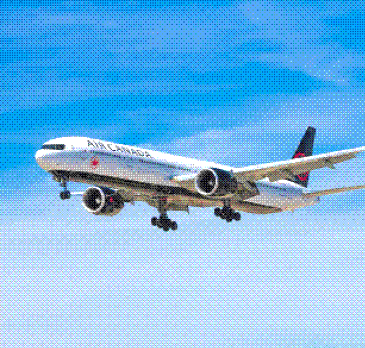 Air Canada passenger airplane in flight against a blue sky