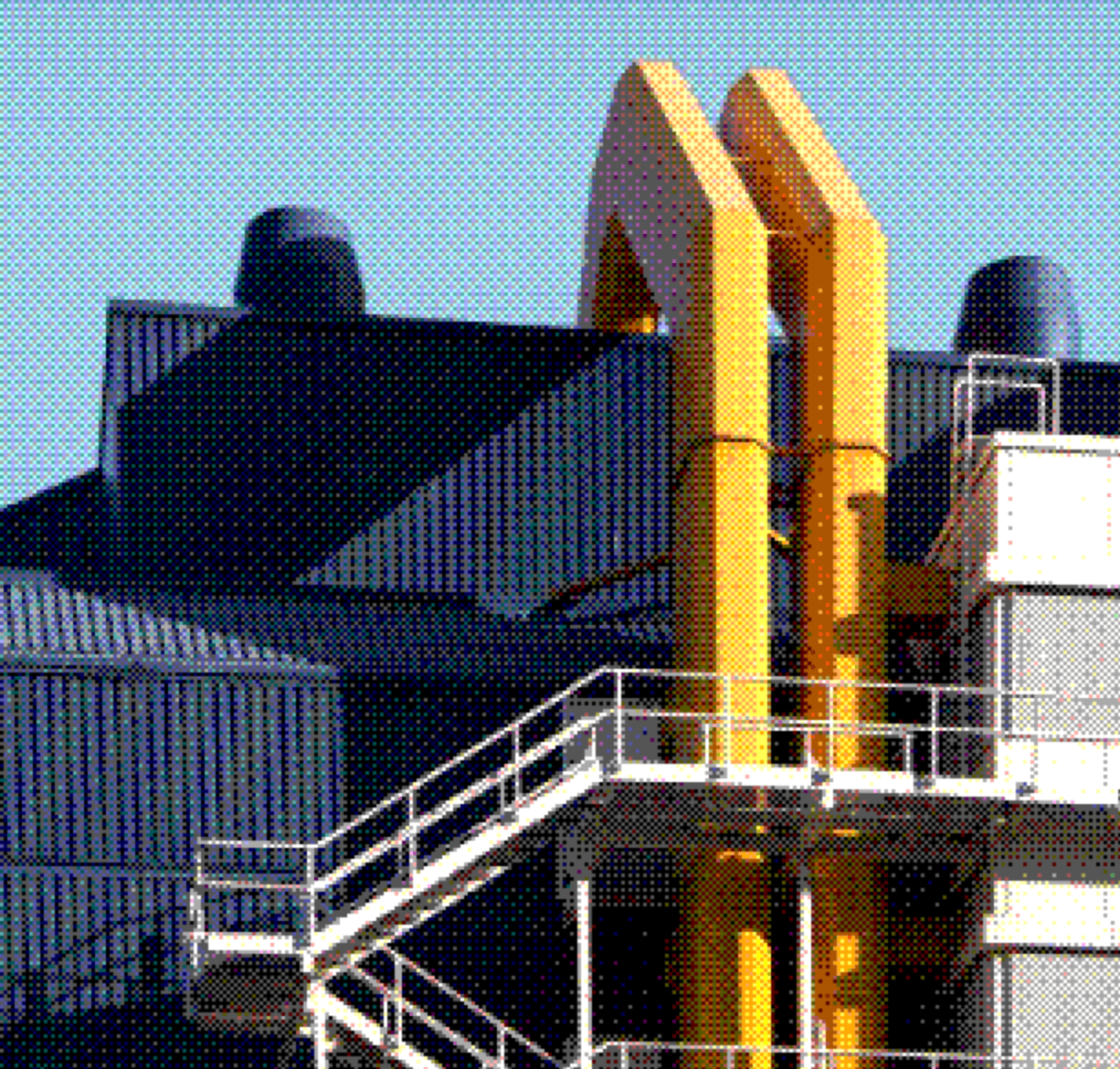 Industrial building with yellow pipes and a steel staircase
