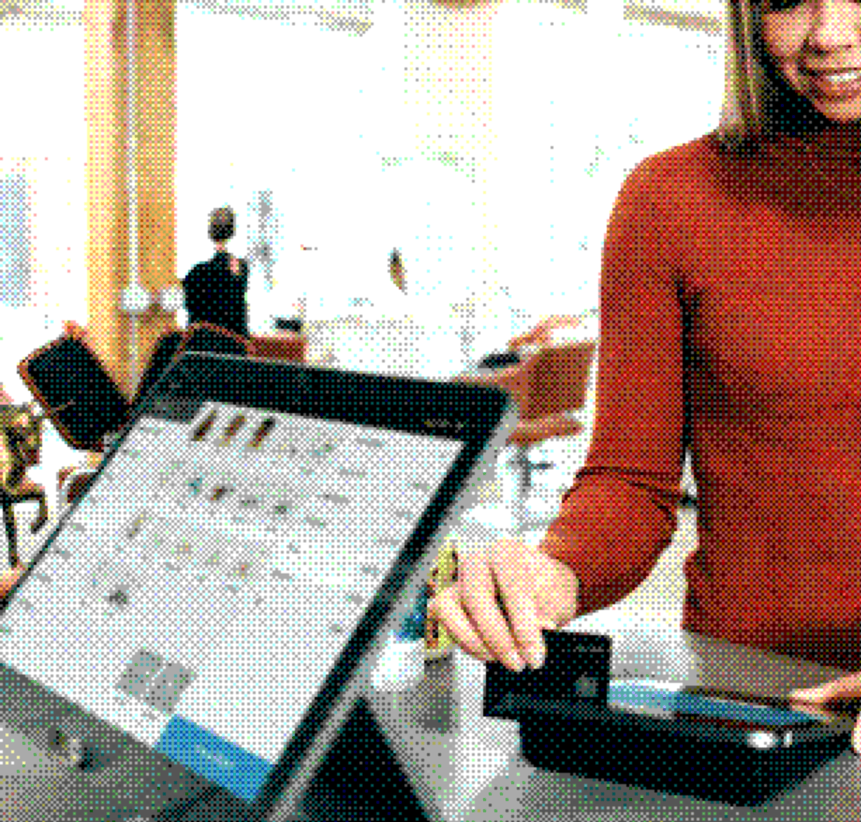 Customer paying by card at a tablet point-of-sale terminal
