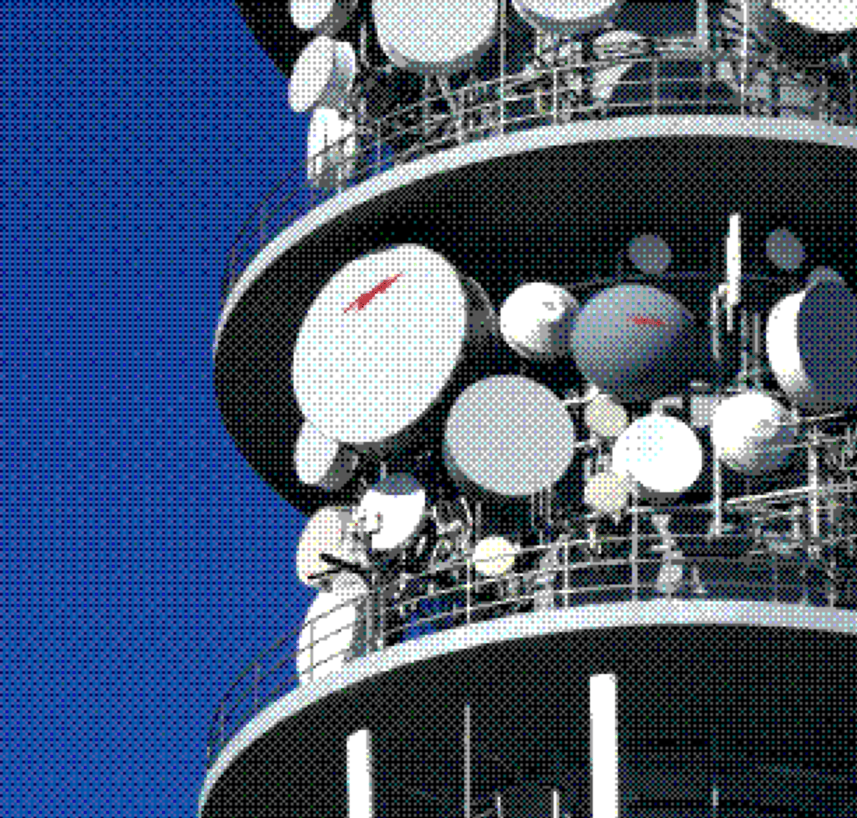 Telecommunications tower with satellite dishes against a blue sky