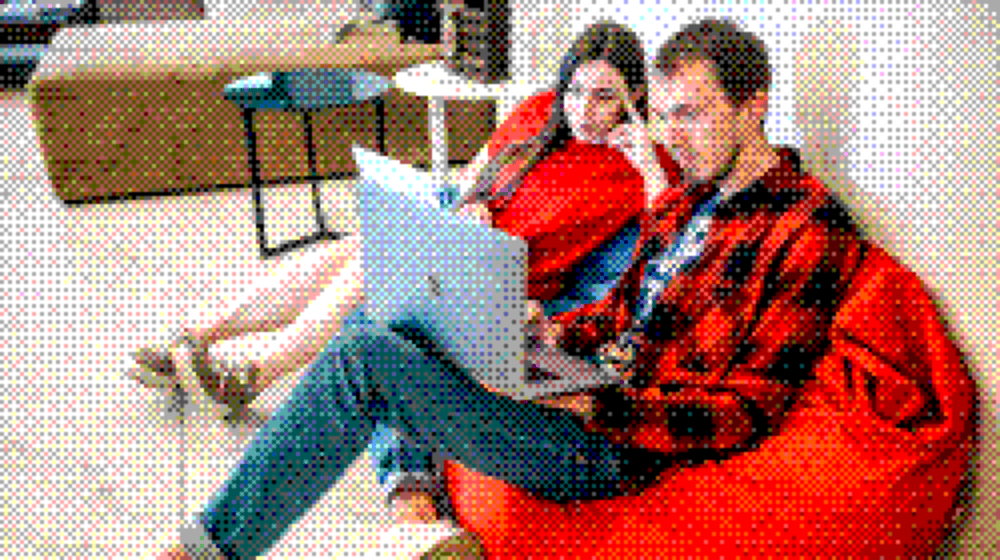 How we approach new projects Two colleagues planning a project together on a bean bag