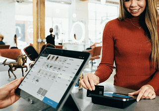 Retail & e-commerce Retail employee using a tablet point-of-sale system