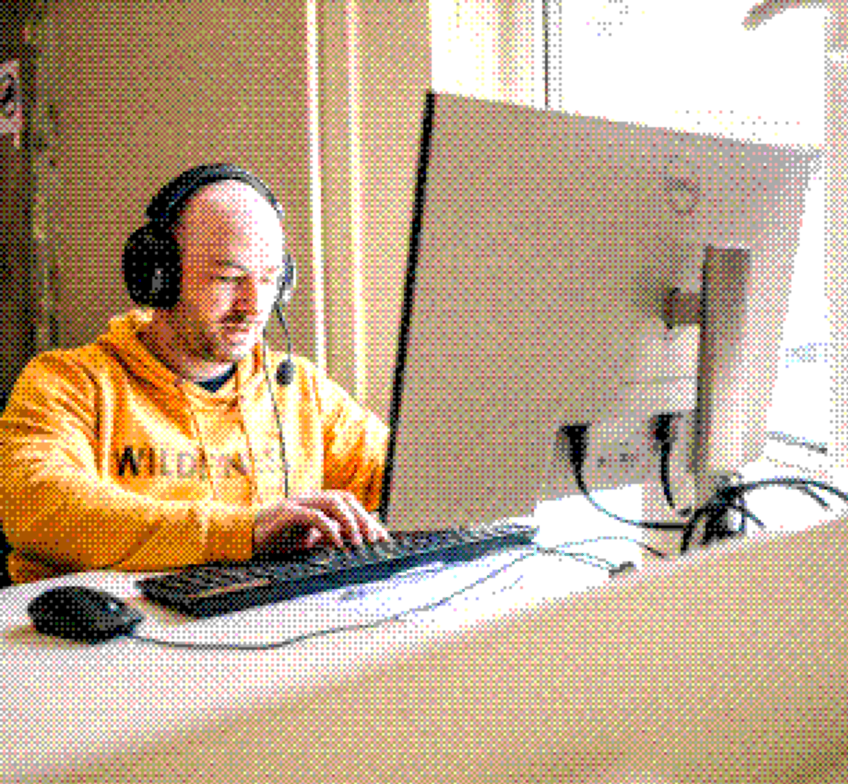 Engineer in a headset working at a computer